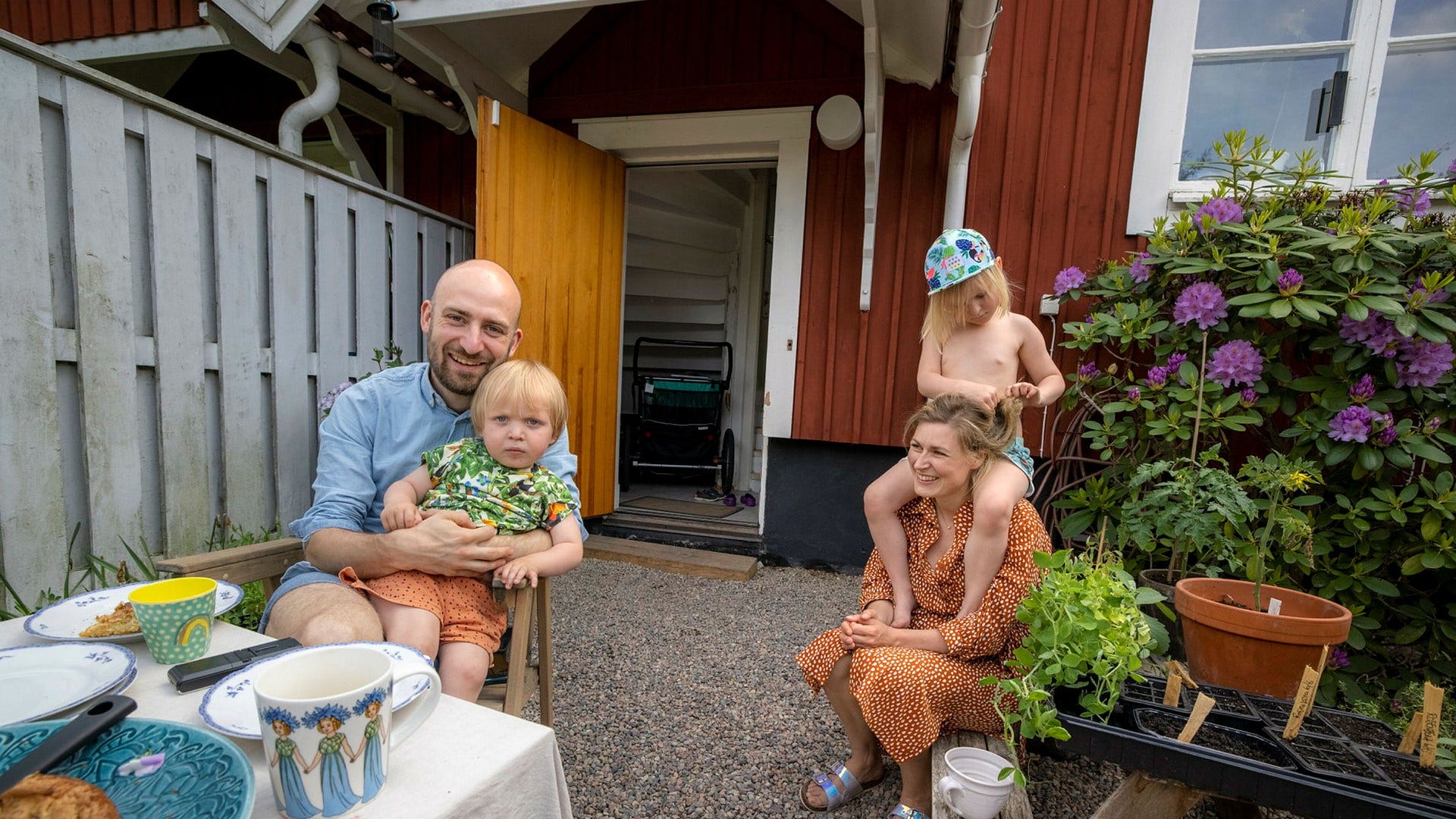 Familjen Nilsson i sin trädgård i Nyköping. Linus Nilsson med sonen Henry i famnen, Johanna Nilsson med dottern Maja på axlarna.