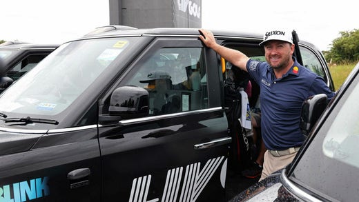 Graeme McDowell and the other players were transported around the track in black taxis.