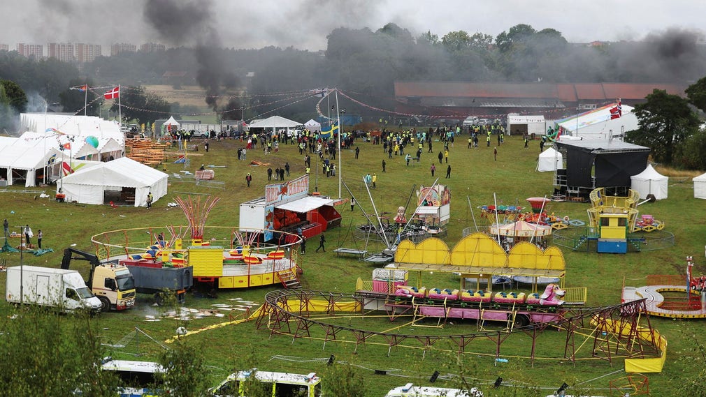 Black smoke rises over the festival grounds after protesters attack an Eritrean cultural festival north of Stockholm.
