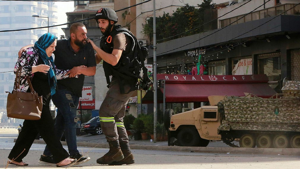 Civila söker skydd under sammandrabbningarna i Beiruts förort Tayouneh på torsdagen.