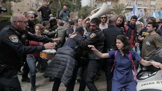 Police try to prevent demonstrators from approaching Netanyahu's house on Al-Izza Street in Jerusalem.  It is his own residence and he lives there now as the residence is being renovated.