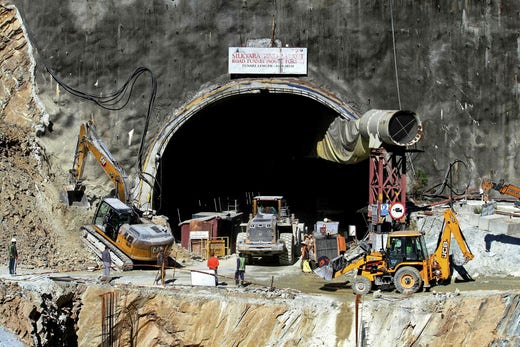 Rescue workers outside the tunnel entrance.