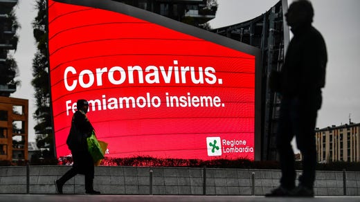 ”Coronavirus. Låt oss stoppa det tillsammans”, manar ett anslag i Milano.